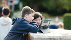 Two ACS pupils look at a tablet