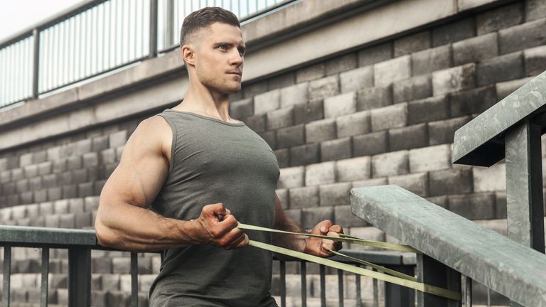 Man works out his arms with a resistance band