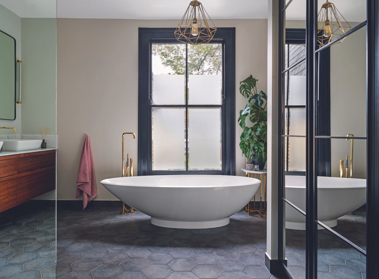 Modern bath and llarge mirror doors on wardrobes in a redesigned en suite bathroom