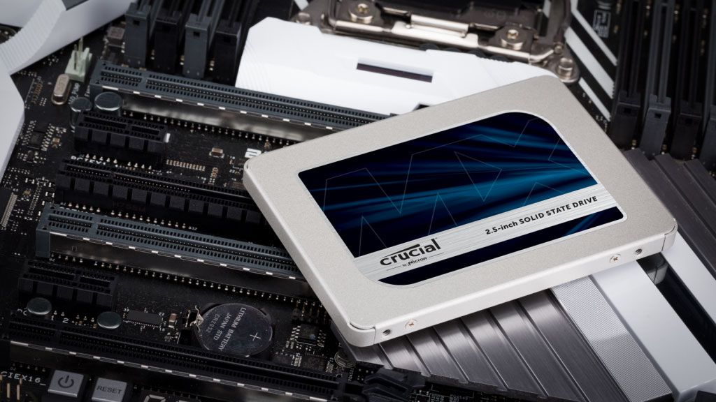 Crucial MX500 SSD laying on top of a motherboard.