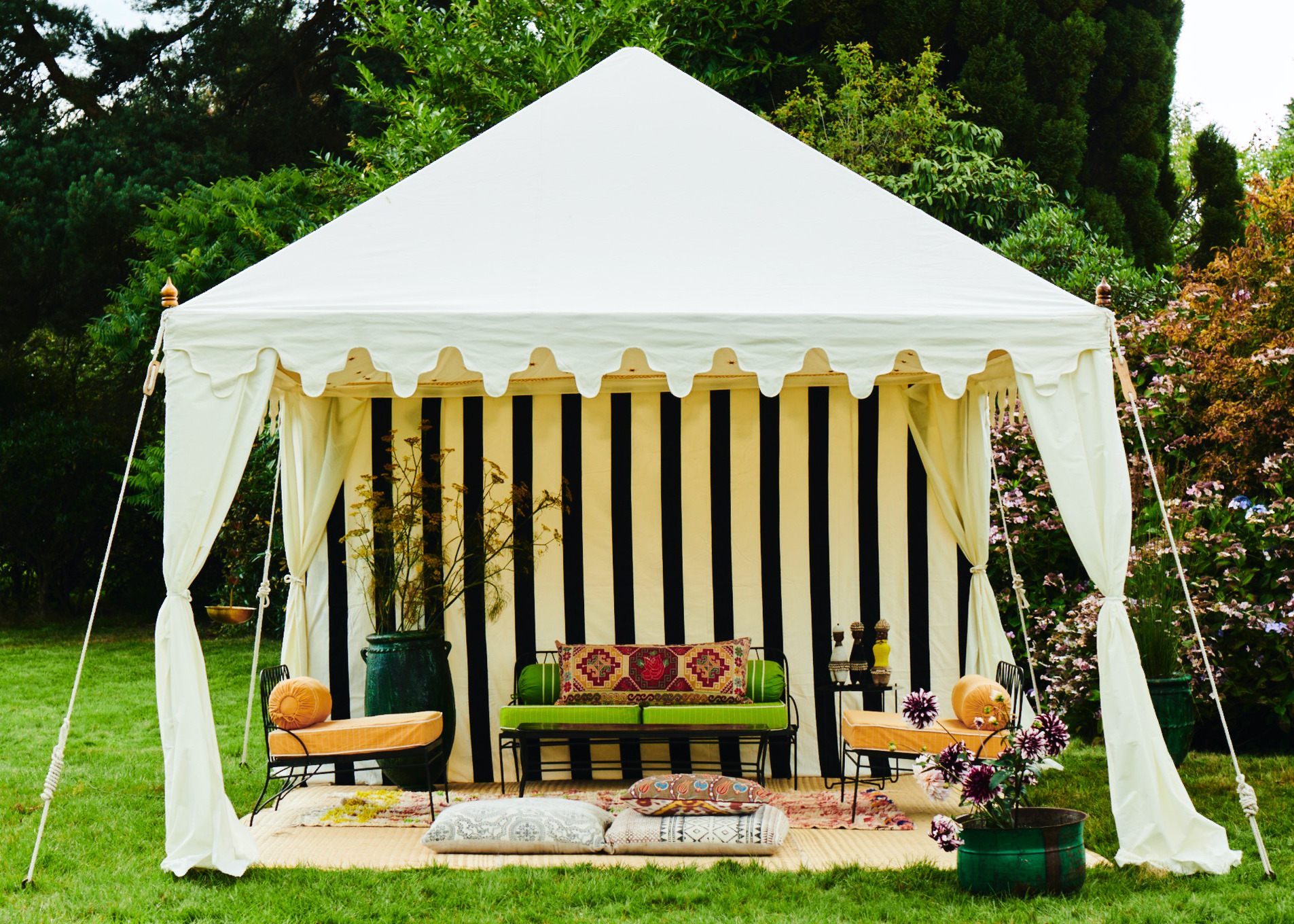 cotton canvas open side pergola style tent with striped backdrop