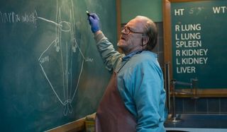 The Autopsy of Jane Doe Brian Cox going over his notes on the chalkboard