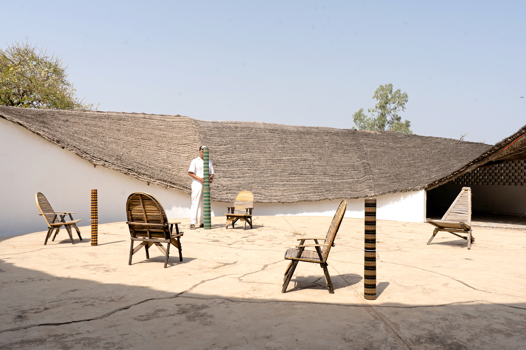colourful woven mats folded over bamboo chairs