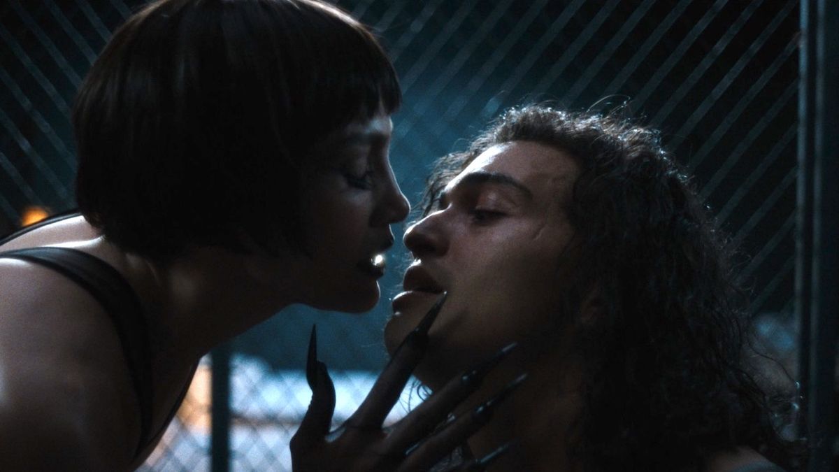 JLo with claws about to kiss a man in Kiss of the Spider Woman 