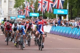Mark Cavendish (Great Britain) celebrates as he beats Sacha Modolo (Italy) and Samuel Dumoulin (France) to win the London-Surrey Classic road race