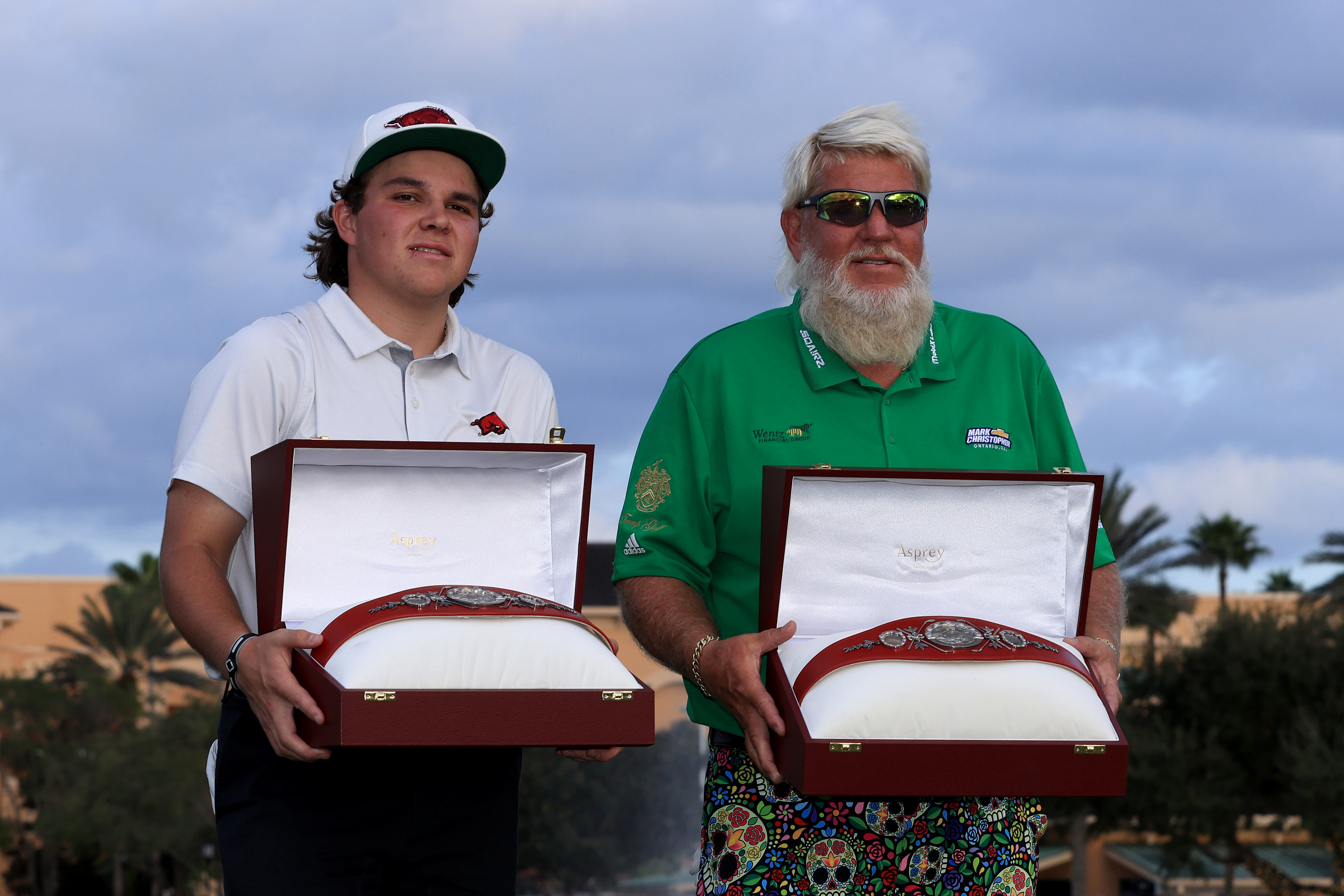 John Daly II and John Daly pose with trophies