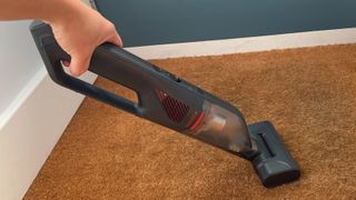 The Eufy HomeVac H30 Mate being used to vacuum a door mat