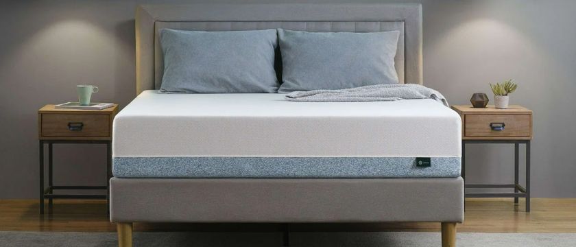 The Zinus Green Tea Memory Foam Mattress on a bed frame in a bedroom