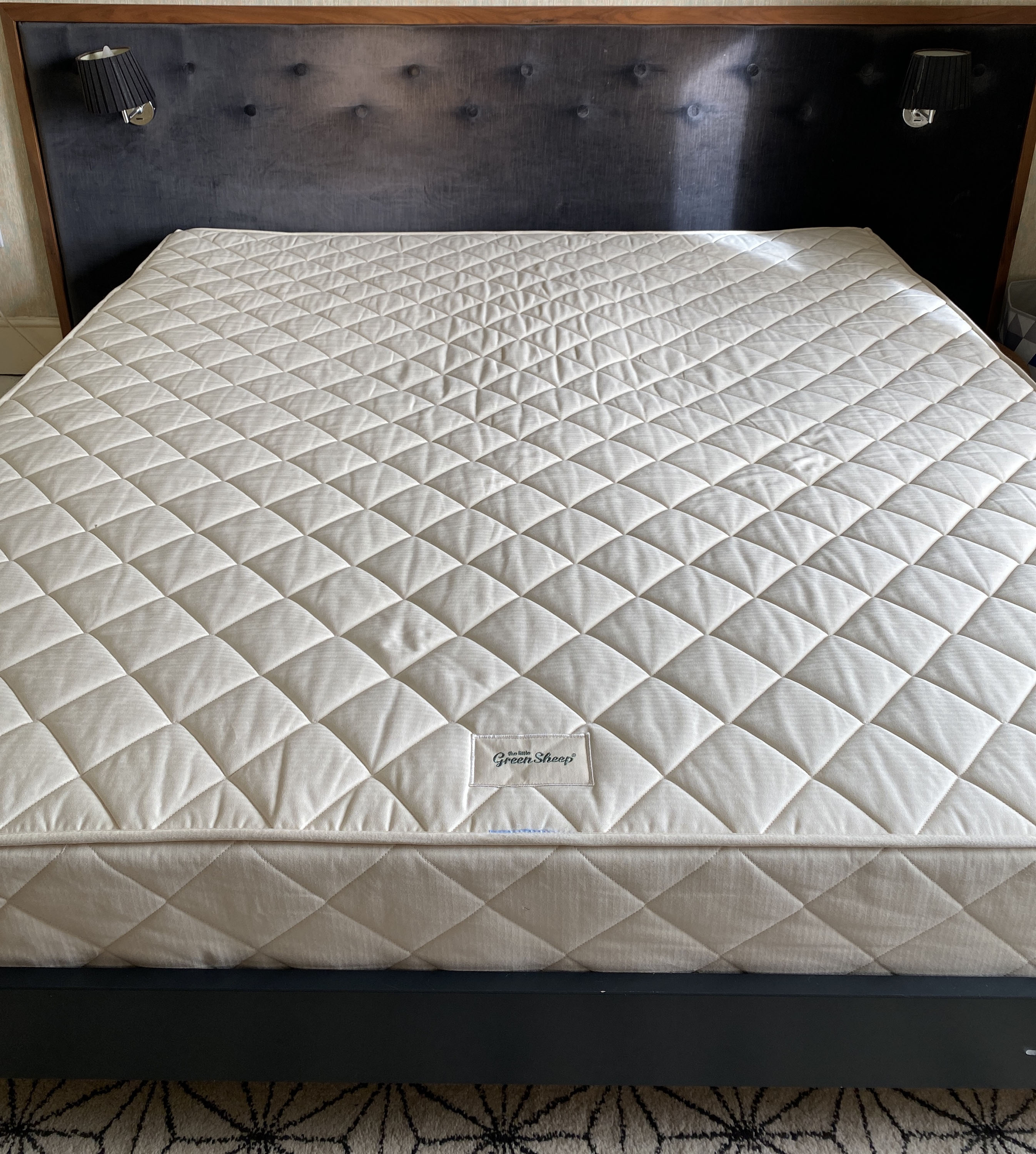 The Little Green Sheep Natural Dual Sided mattress on bed