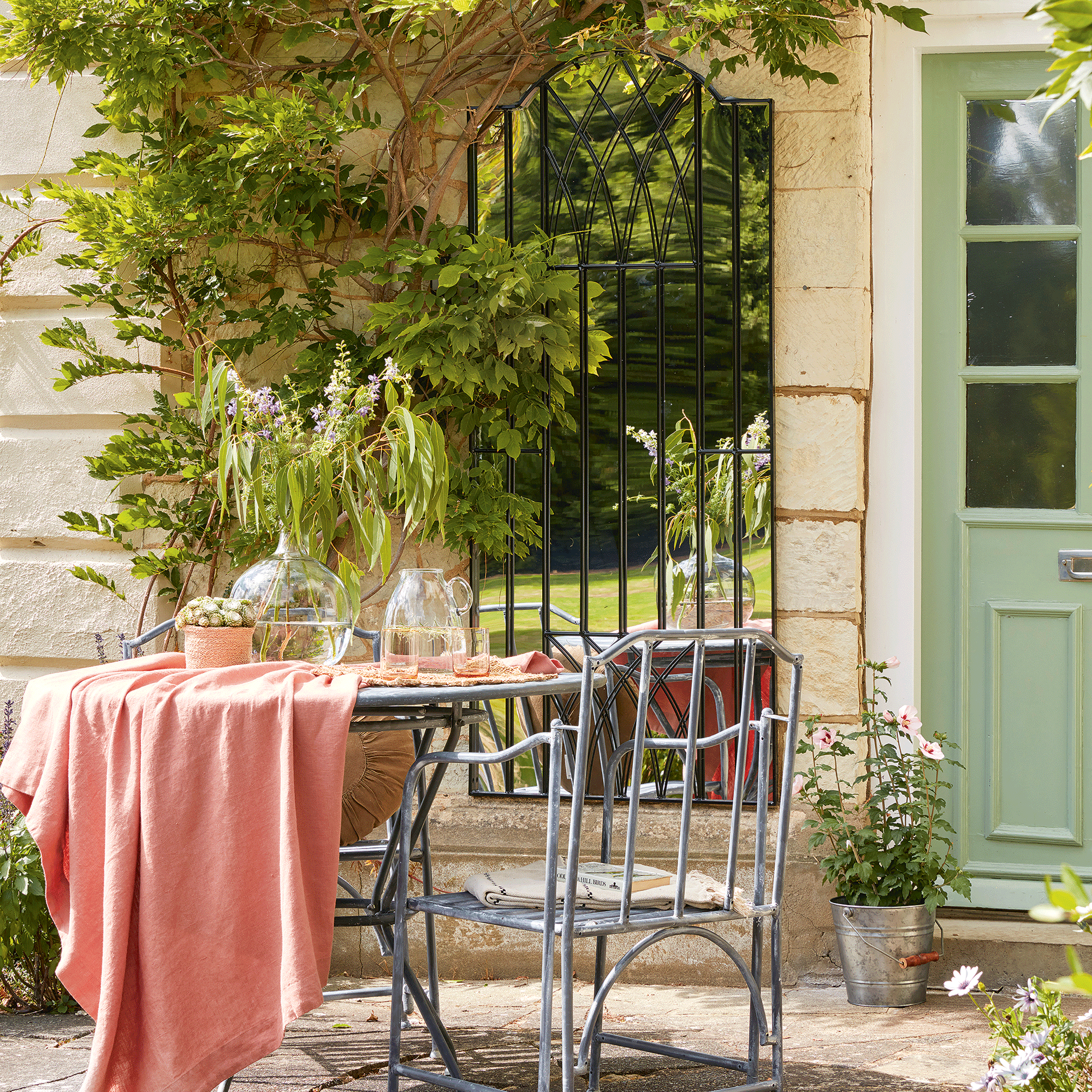 Bistro set with garden mirror in background