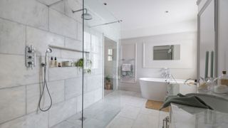 white marble wet room bathroom trend with gold taps and fittings