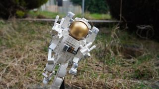 Lego Creator 3-in-1 Space Astronaut posed in grass.