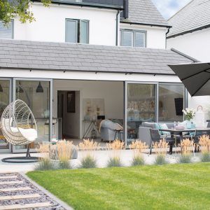 exterior of house with green lawn and hanging swing