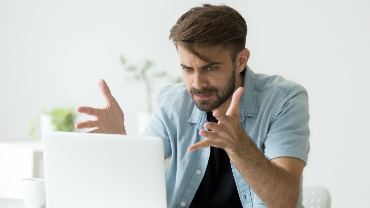 A young man frustrated that his laptop isn&amp;#039;t working