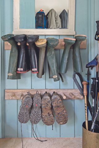 two rows of peg rails for hanging shoes and boots