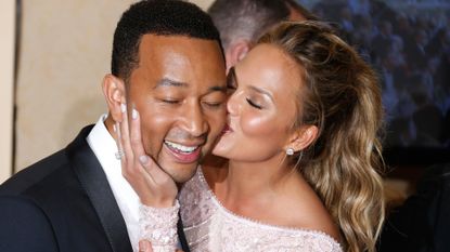John Legend (L) and model Chrissy Teigen pose in the press room during the 72nd Annual Golden Globe Awards at The Beverly Hilton Hotel on January 11, 2015 in Beverly Hills, California