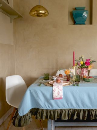 table setting with a blue table cloth and colorful table decor