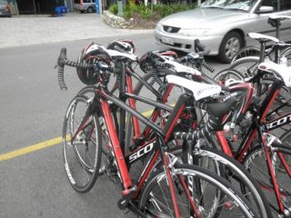 A stack of red and black Scott F01 bikes