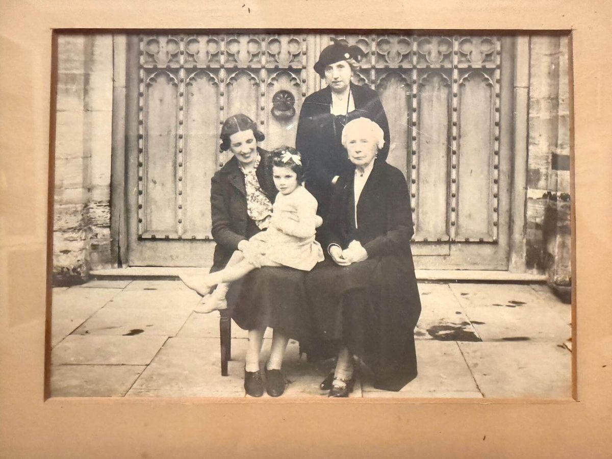 Black-and-white group portrait of four generations of women in the same family.