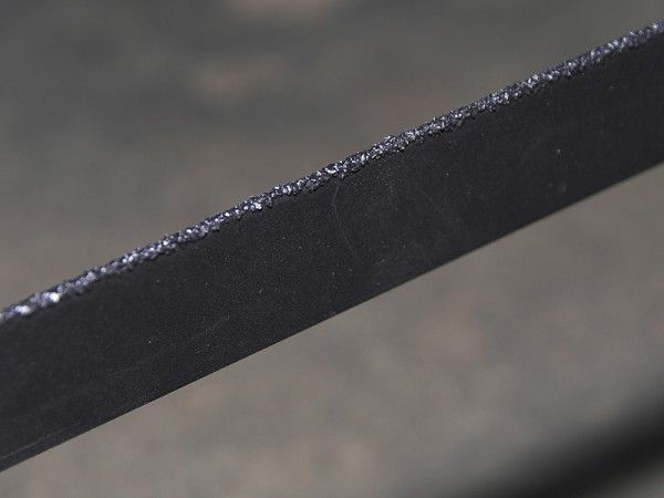 The tungsten carbide-coated blade gently grinds - not rips - its way through carbon fiber.