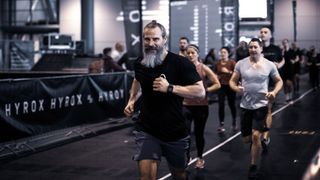 Man running at a HYROX event
