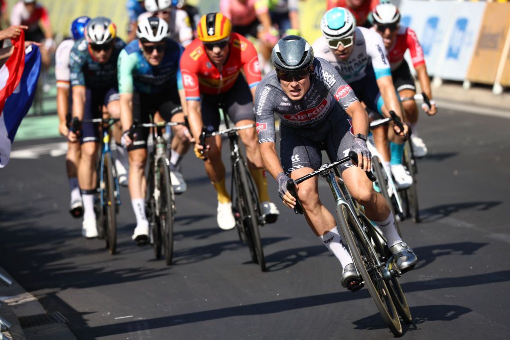 Alpecin-Deceuninck team's Belgian rider Jasper Philipsen (C) cycles past the finish line to win ahead of second-placed Bahrain - Victorious team's German rider Phil Bauhaus (R) and third-placed Uno-X Mobility team's Norwegian rider Alexander Kristoff (3rd L) during the 16th stage of the 111th edition of the Tour de France cycling race, 188,6 km between Gruissan and Nimes, southern France, on July 16, 2024. (Photo by Anne-Christine POUJOULAT / AFP)