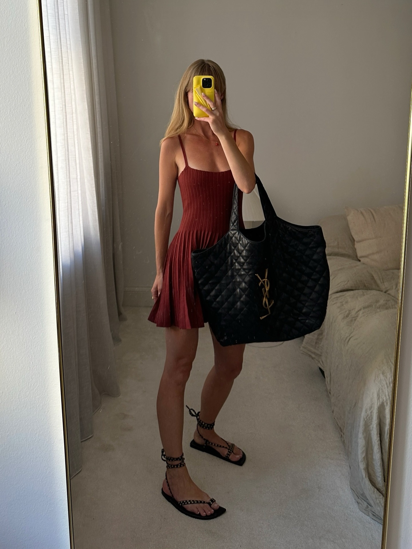 Influencer wearing a burgundy dress, YSL tote, and ankle-tie sandals