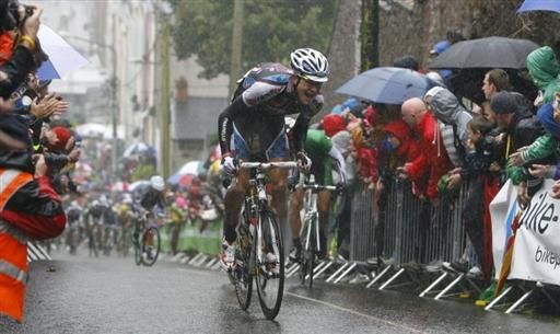 Rider's push on up St Patrick's Hill, in spite of the torrential conditions
