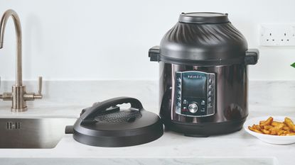An air fryer on top of a marble kitchen counter