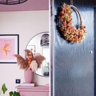 Hallway with black front door and wreath