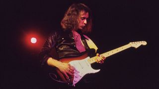 British guitarist and songwriter Ritchie Blackmore, wearing a black shirt, playing a Fender Stratocaster in sunburst, as his band, British rock band Deep Purple, performs live, 1972