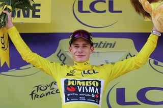 Jumbo-Visma's Danish rider Jonas Vingegaard celebrates on the podium with the overall leader's yellow jersey after the 14th stage of the 110th edition of the Tour de France cycling race, 152 km between Annemasse and Morzine Les Portes du Soleil, in the French Alps, on July 15, 2023. (Photo by Thomas SAMSON / AFP)