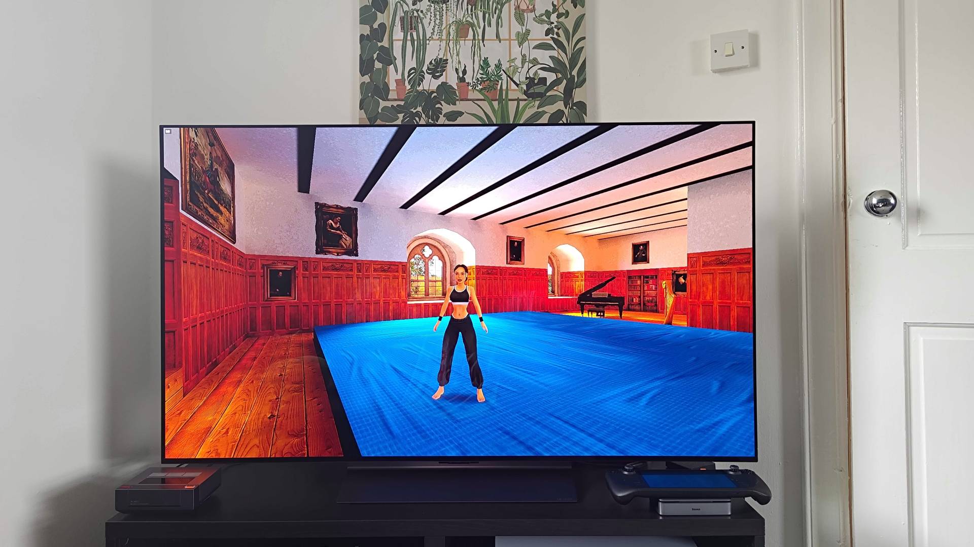 Steam Deck connected to LG OLED C4 TV sitting on Baseus docking station with Tomb Raider gameplay on screen.