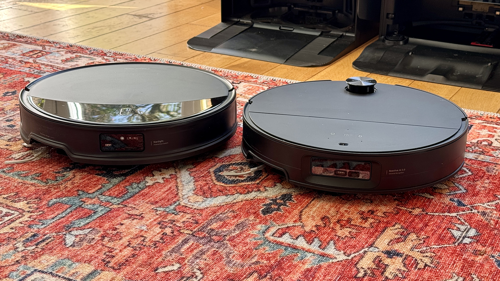 Roborock Saros 10R and Saros 10 robot vacuums side by side in reviewer's house