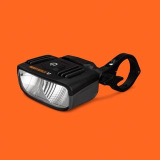 An black bike light on an orange background