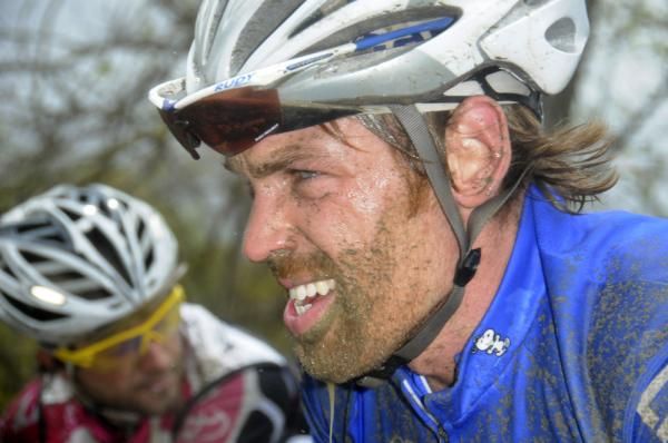 Mud and determination mark the face of a rider during the Tour of the Battenkill