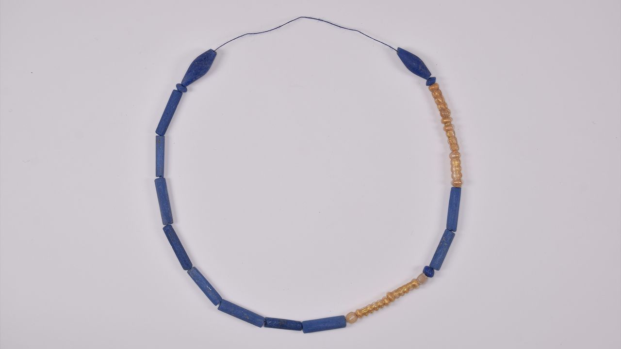 A necklace of blue and gold discovered in one of the tombs.