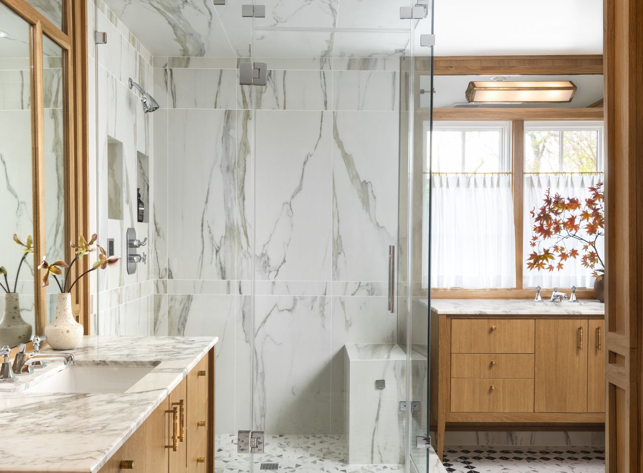 A shower area built with marble walls and marble bench