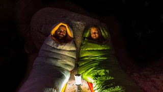 Man and woman sitting in sleeping bags