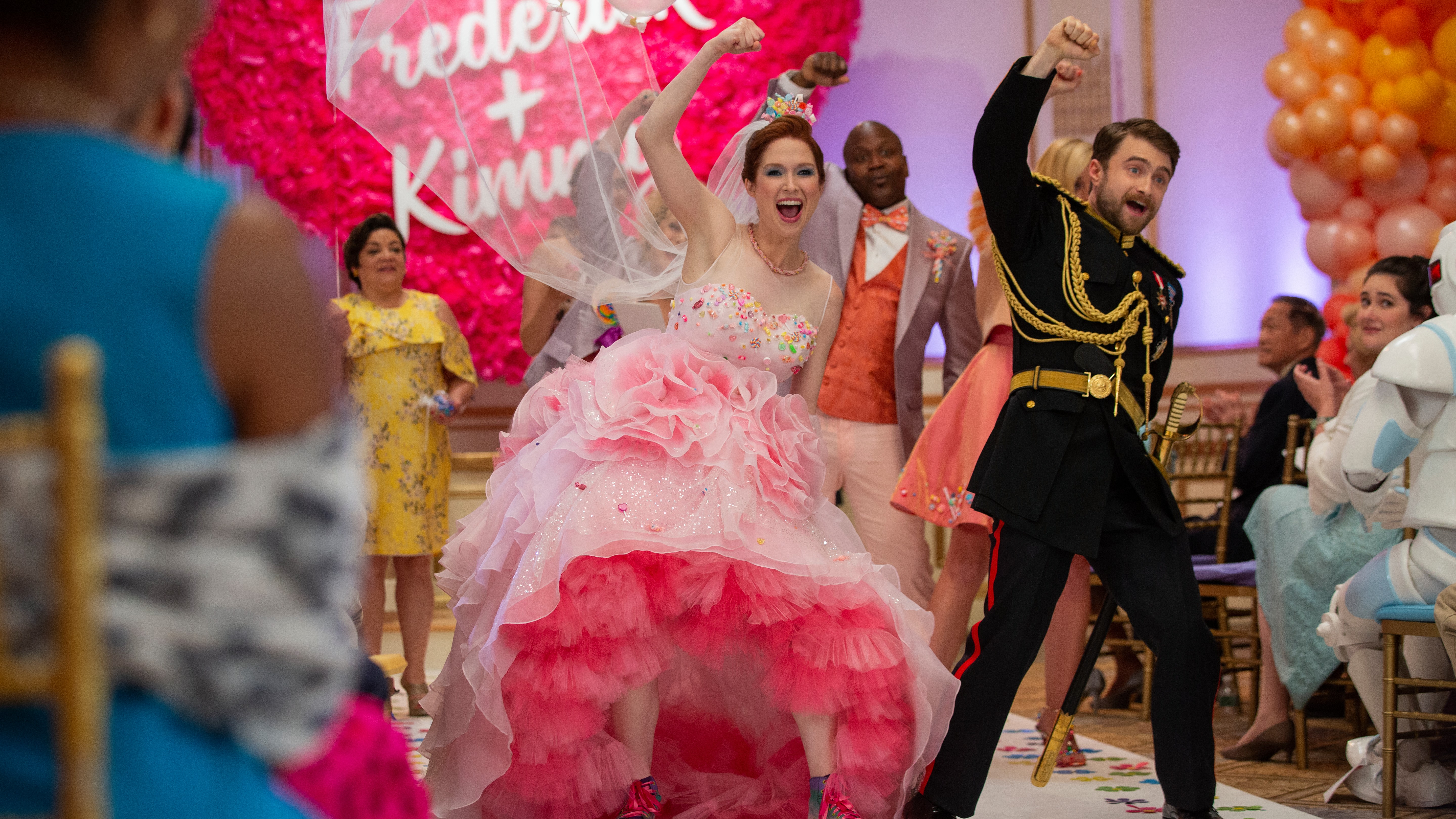 L-R: Kimmy Schmidt (Ellie Emper) and Prince Frederick (Daniel Radcliffe) celebrate in the aisle on wedding day in a scene from Netflix's "Unbreakable Kimmy Schmidt: Kimmy Vs. The Reverend"
