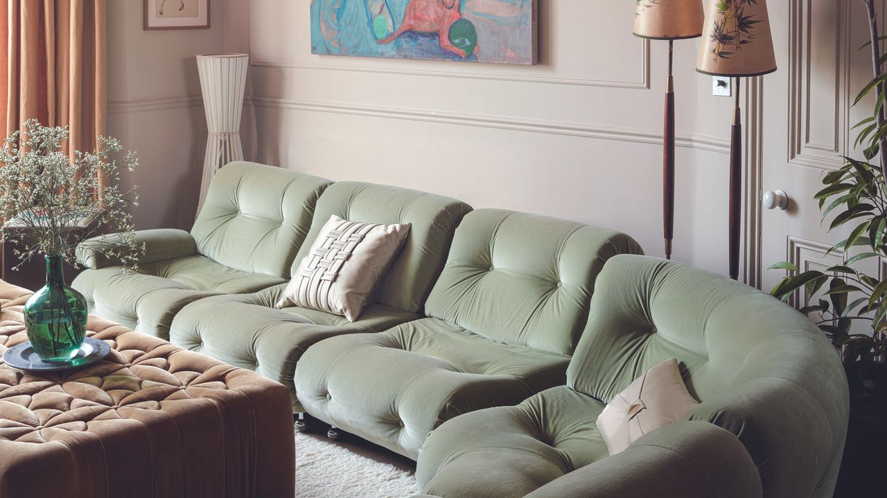 Pink living room with green sofa