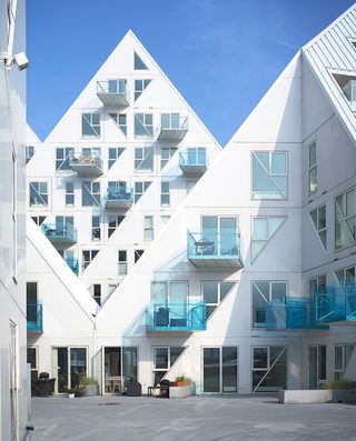 Large triangular shaped apartment buildings with glass balconies