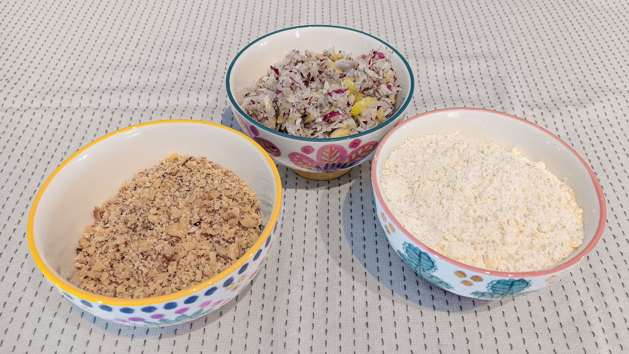 Three bowls of food chopped in the KitchenAid food chopper