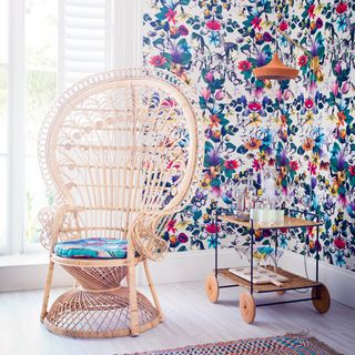 room with hot tropics wallpaper and cane chair