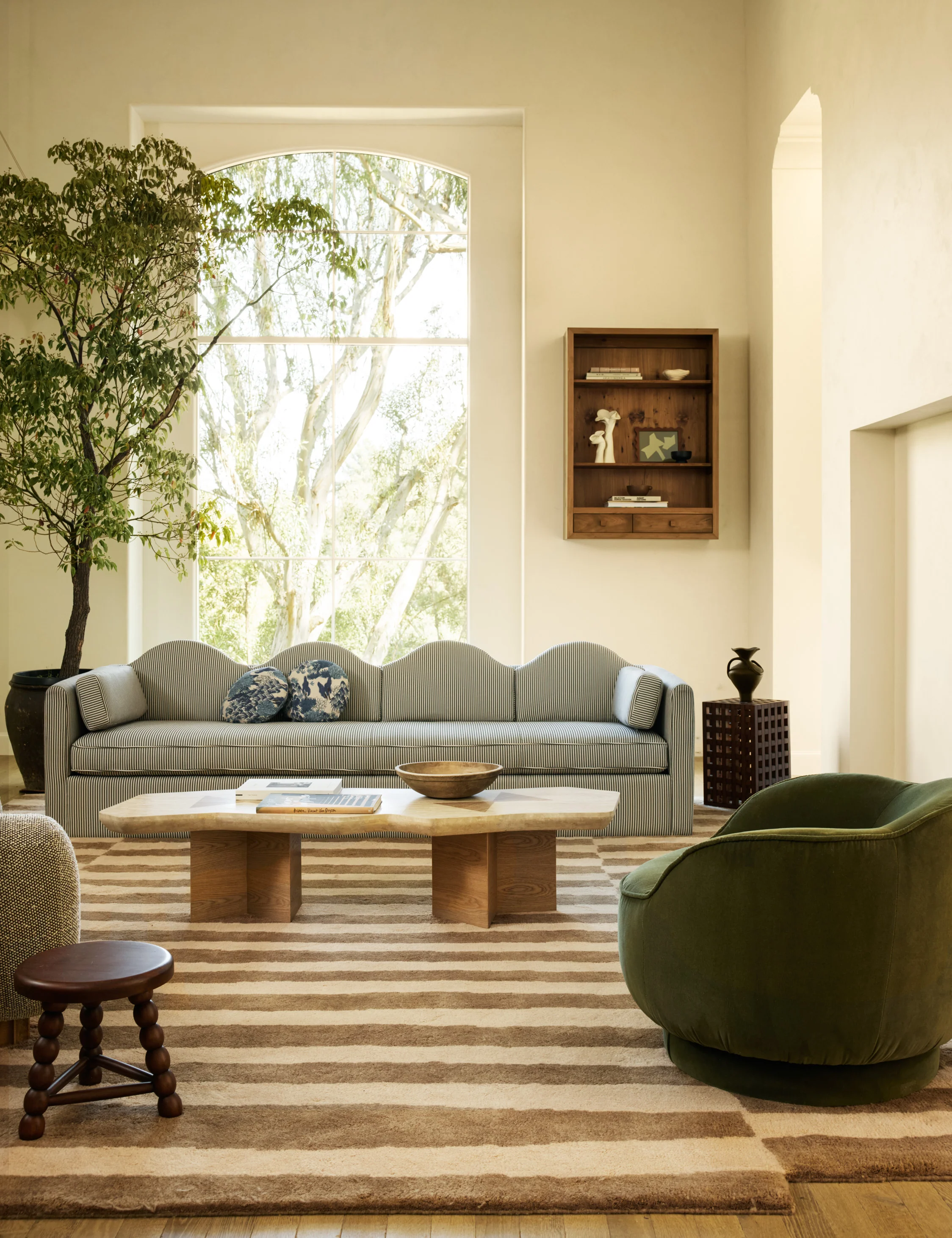 Striped sinuous sofa featured in a modern brightly lit living room featuring playful furniture