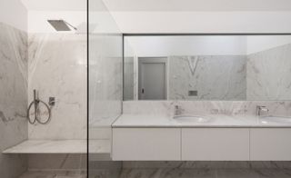 Luxurious en-suite bathrooms in white Portuguese marble