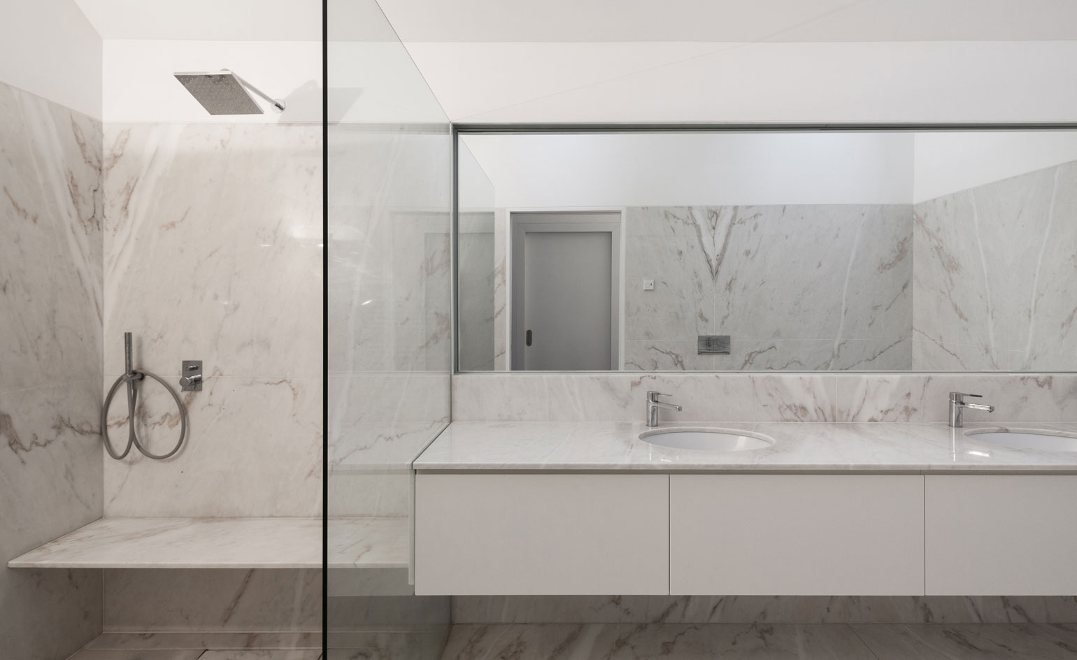 Luxurious en-suite bathrooms in white Portuguese marble