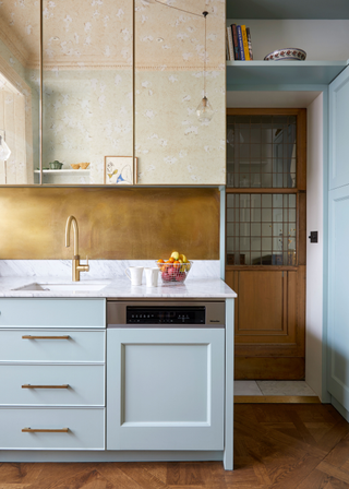 Blue cabinets with white marble countertops and mirrors cupboards