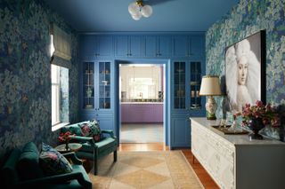 A kitchen and passageway with a strong color block
