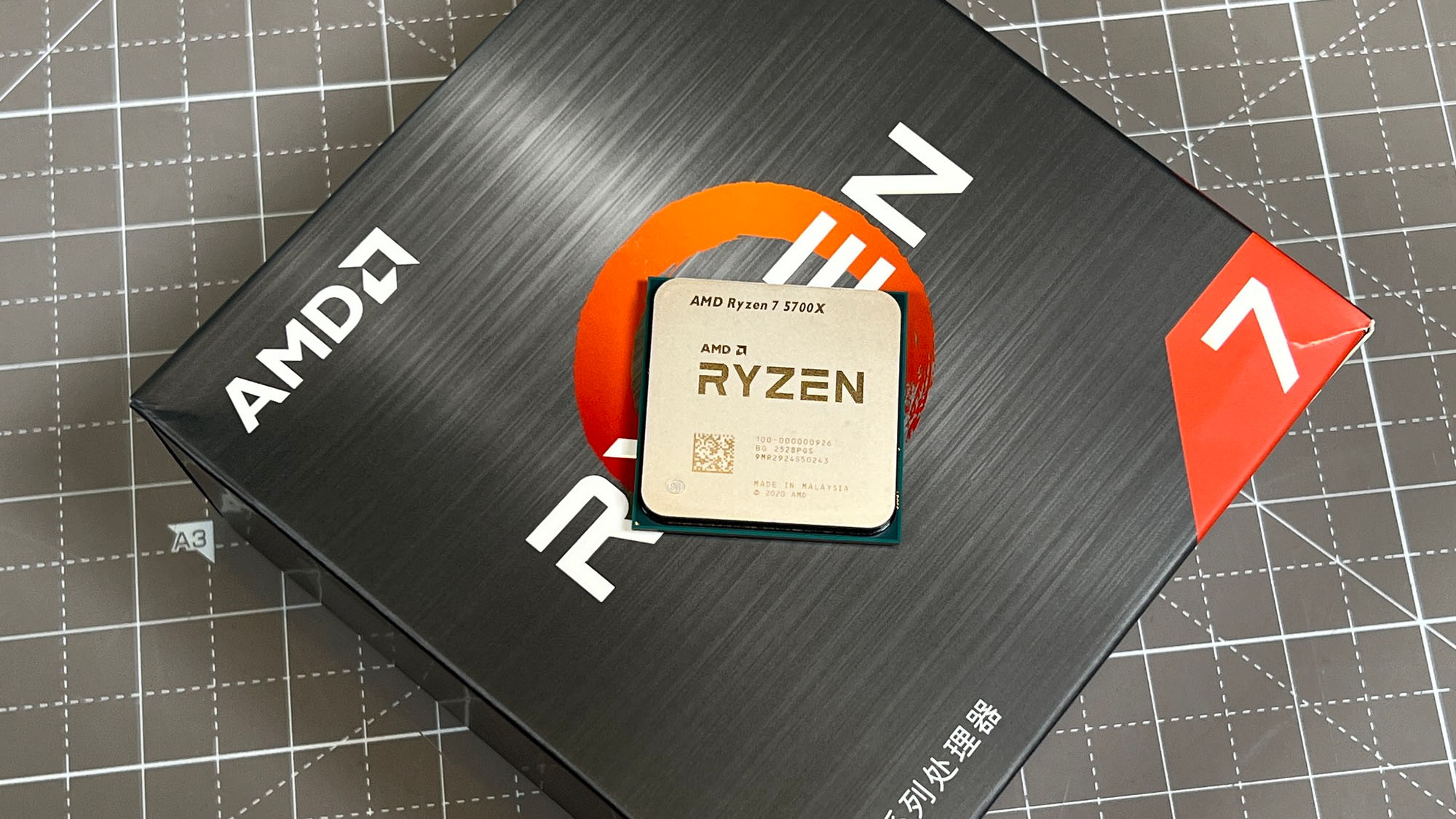An AMD Ryzen 7 5700X sitting on top of its retail packaging
